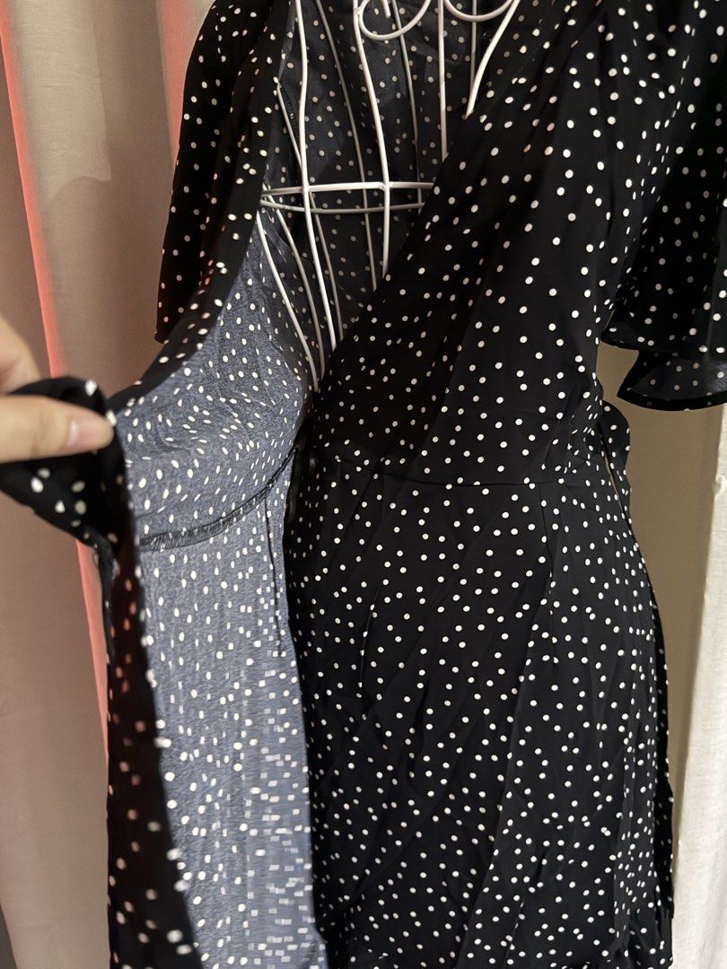 Black White Polka Dot Wrap Dress Medium 90cm (Category: Dresses) located in Cebu City. Submitted by jovjovcim60300 (Listing ID 1470697627, Image 2). Description: Black wrap dress with white polka dots all over. Short flutter sleeves, V-neckline, and a ruffled hem detail. Tie-wrap side closure. Length measures 90cm. Size medium. Lightweight fabric, easy to style for casual outings or weekend wear..