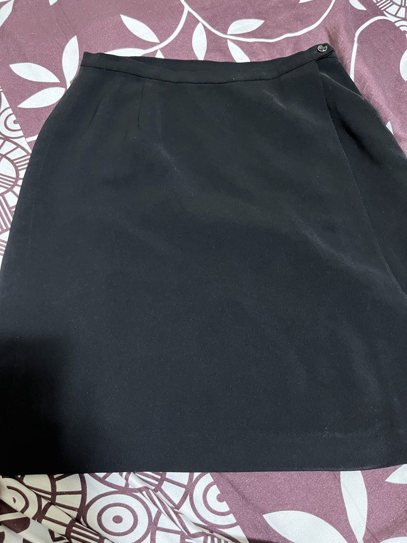 Black wrap skirt with button closure (Category: Skirts) located in Manila. Submitted by elocin_0428 (Listing ID 1470565546, Image 1). Description: Color: Classic Black Material: Smooth, premium fabric with full lining for all-day comfort Design: Trendy asymmetrical overlapping front panel Size: 7 or meduim .