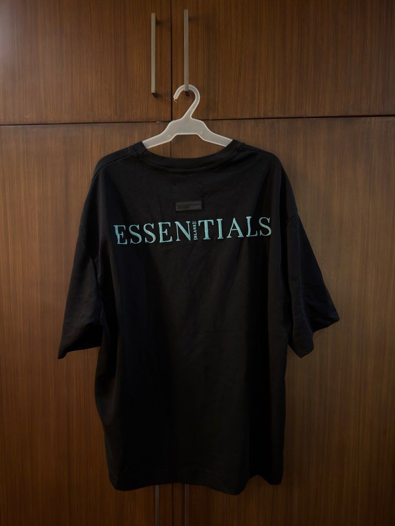 {BLANK}: Essentials Black T-shirt Size XL (Category: Tshirts & Polo Shirts ) located in Paranaque City. Submitted by preloveditems111 (Listing ID 1470716217, Image 2). Description: - Brand: Essentials - Color: Solid black with mint green prints (small front, large back) - Size: XL (relaxed oversized fit, dropped shoulders) - Material: Premium heavyweight cotton - Condition: Brand new with hang tag and woven neck label - Style: Streetwear / clean 