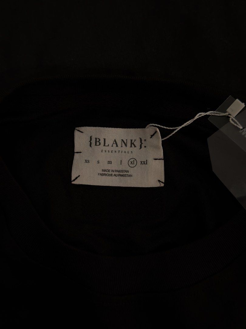 {BLANK}: Essentials Black T-shirt Size XL (Category: Tshirts & Polo Shirts ) located in Paranaque City. Submitted by preloveditems111 (Listing ID 1470716217, Image 3). Description: - Brand: Essentials - Color: Solid black with mint green prints (small front, large back) - Size: XL (relaxed oversized fit, dropped shoulders) - Material: Premium heavyweight cotton - Condition: Brand new with hang tag and woven neck label - Style: Streetwear / clean 