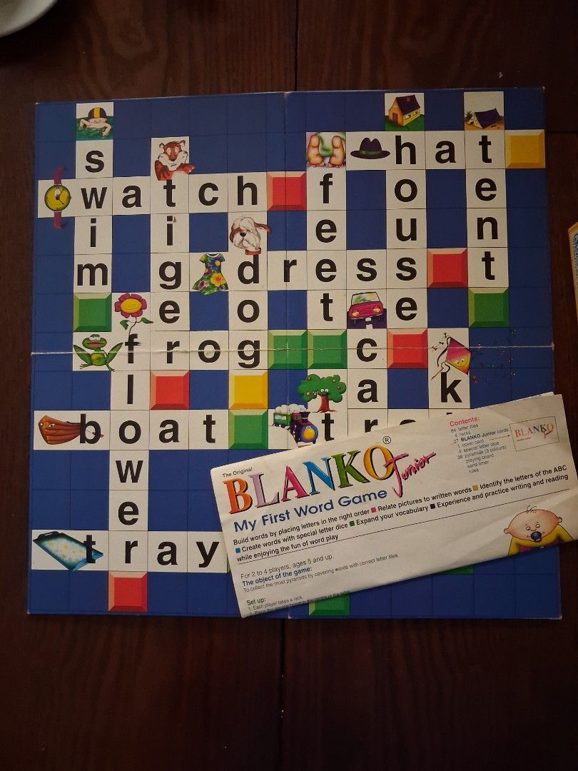 Blanko Junior My First Word Game (Category: Board Games & Puzzles) located in Marikina City. Submitted by misskawaii (Listing ID 1470571848, Image 3). Description: - Educational word building board game designed for kids - Teaches spelling and vocabulary through fun pictures and matching words - Complete set: letter tiles, colored pyramid tokens, letter dice, cards (missing cover card), sand timer, folding board, and instructions - Includes origi