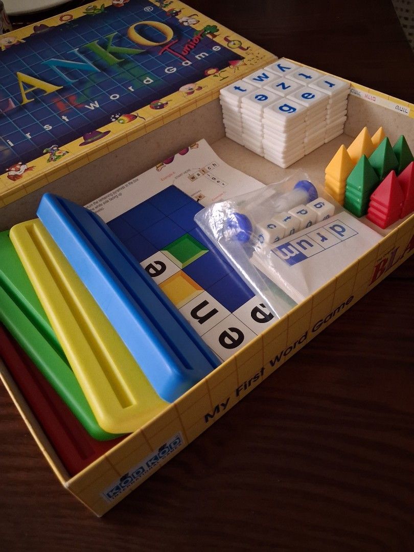 Blanko Junior My First Word Game (Category: Board Games & Puzzles) located in Marikina City. Submitted by misskawaii (Listing ID 1470571848, Image 2). Description: - Educational word building board game designed for kids - Teaches spelling and vocabulary through fun pictures and matching words - Complete set: letter tiles, colored pyramid tokens, letter dice, cards (missing cover card), sand timer, folding board, and instructions - Includes origi