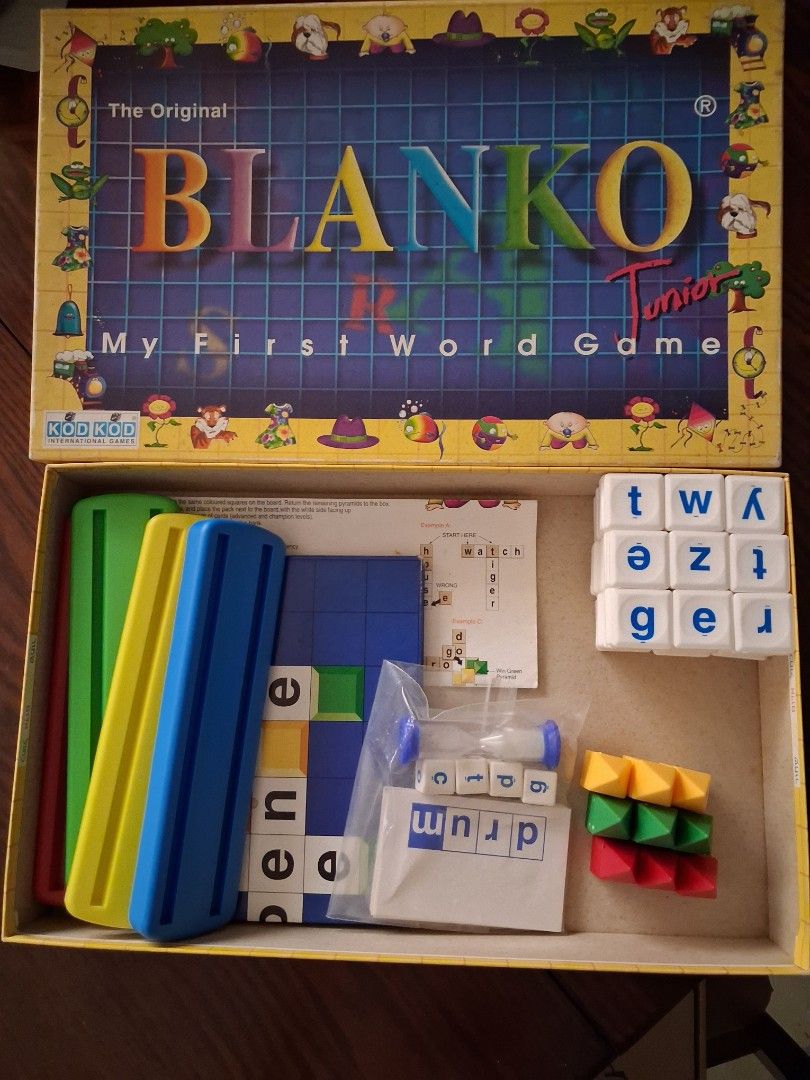 Blanko Junior My First Word Game (Category: Board Games & Puzzles) located in Marikina City. Submitted by misskawaii (Listing ID 1470571848, Image 1). Description: - Educational word building board game designed for kids - Teaches spelling and vocabulary through fun pictures and matching words - Complete set: letter tiles, colored pyramid tokens, letter dice, cards (missing cover card), sand timer, folding board, and instructions - Includes origi