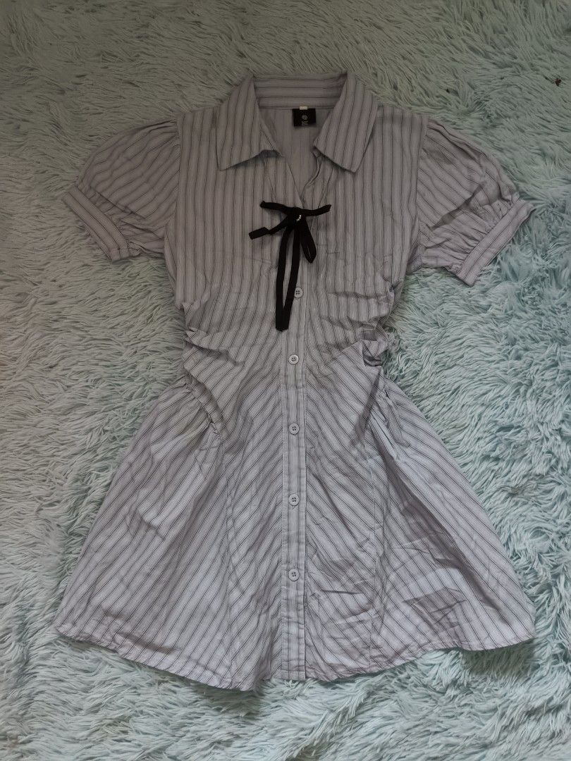 Light blue striped collared dress with black bow (Category: Dresses) located in Quezon City. Submitted by alluring.avenue (Listing ID 1470670983, Image 1). Description: - Details: Collared neckline, front button closure, and charming black ribbon tie - Sleeves: Short puff sleeves - Fit: Fitted waist with a flattering flared skirt.