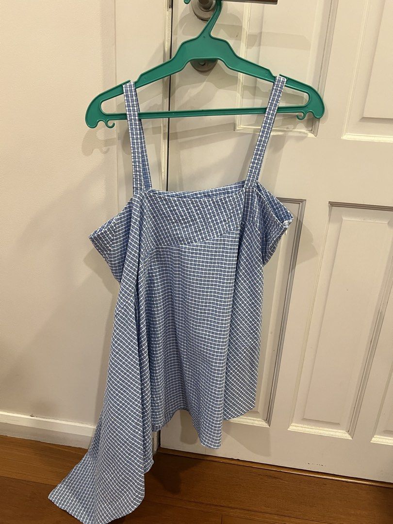 Blue and White Gingham Asymmetric Cami Top (Category: Sleeveless) located in San Juan City. Submitted by thrillfinder (Listing ID 1470579547, Image 1). Description: JILL LAO top - Classic blue and white gingham pattern - Trendy asymmetric drape on the left side - Flattering square neckline with thin spaghetti straps - Lightweight, breathable fabric ideal for warm weather - Convenient side zipper closure - Excellent, clean, and ready-to-wear condi