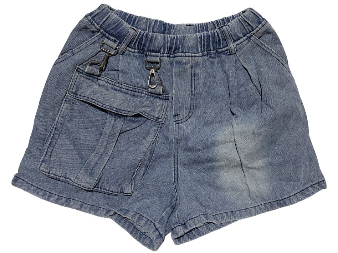 Blue Denim Cargo Shorts with Elastic Waist (Category: Shorts) located in Cavite. Submitted by grandearth.39df3f (Listing ID 1470678018, Image 1). Description: - Style: Relaxed fit blue denim shorts with a pre-washed/faded finish - Waistband: Elastic with gathering and elastic back detail for extra comfort - Pockets: Large cargo pocket on the left leg with metal clasps and D-rings, plus plain back pockets - Condition: Brand new / Excellent quality