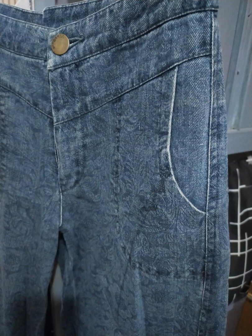 Blue denim pants with floral pattern (Category: Jeans) located in Manila. Submitted by h4ch1 (Listing ID 1470580057, Image 1). Description: - Style: High-waisted, wide leg, relaxed fit - Design: Subtle all-over floral pattern with brass-tone button closure - Features: Functional front pockets and clean front panel stitching - Material: Sturdy, high-quality denim - Perfect for: Casual daily wear and effortless styling.