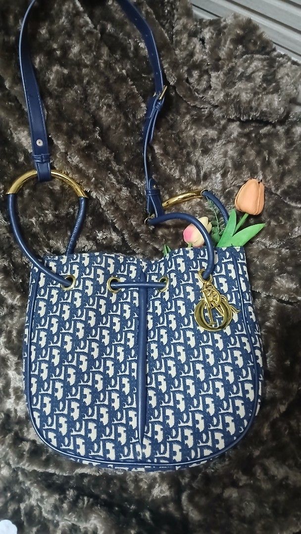 Blue monogram bucket bag with gold hardware (Category: Luxury Bags & Wallets) located in Taguig. Submitted by jegadablo (Listing ID 1470740881, Image 3). Description: - Stylish blue and cream monogram pattern - Dark blue faux leather trim and adjustable shoulder strap - Shiny gold hardware with cute dangling charm - Clean fabric-lined interior with an open slip pocket - Excellent, ready-to-use condition.