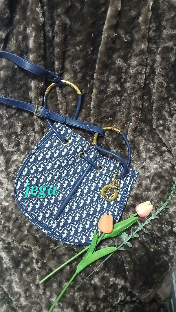 Blue monogram bucket bag with gold hardware (Category: Luxury Bags & Wallets) located in Taguig. Submitted by jegadablo (Listing ID 1470740881, Image 2). Description: - Stylish blue and cream monogram pattern - Dark blue faux leather trim and adjustable shoulder strap - Shiny gold hardware with cute dangling charm - Clean fabric-lined interior with an open slip pocket - Excellent, ready-to-use condition.