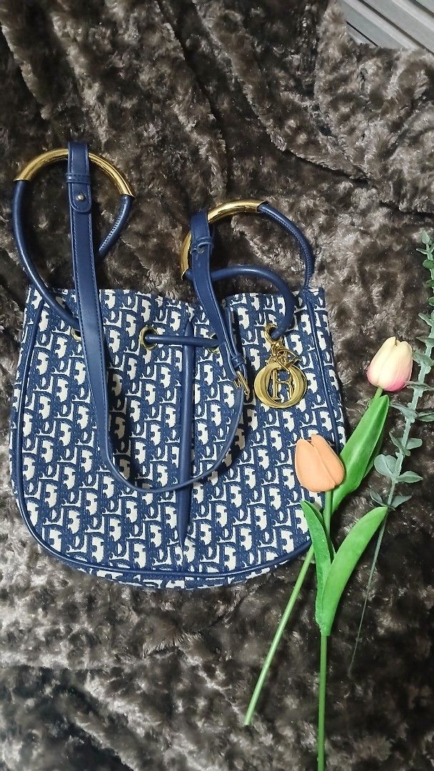 Blue monogram bucket bag with gold hardware (Category: Luxury Bags & Wallets) located in Taguig. Submitted by jegadablo (Listing ID 1470740881, Image 1). Description: - Stylish blue and cream monogram pattern - Dark blue faux leather trim and adjustable shoulder strap - Shiny gold hardware with cute dangling charm - Clean fabric-lined interior with an open slip pocket - Excellent, ready-to-use condition.