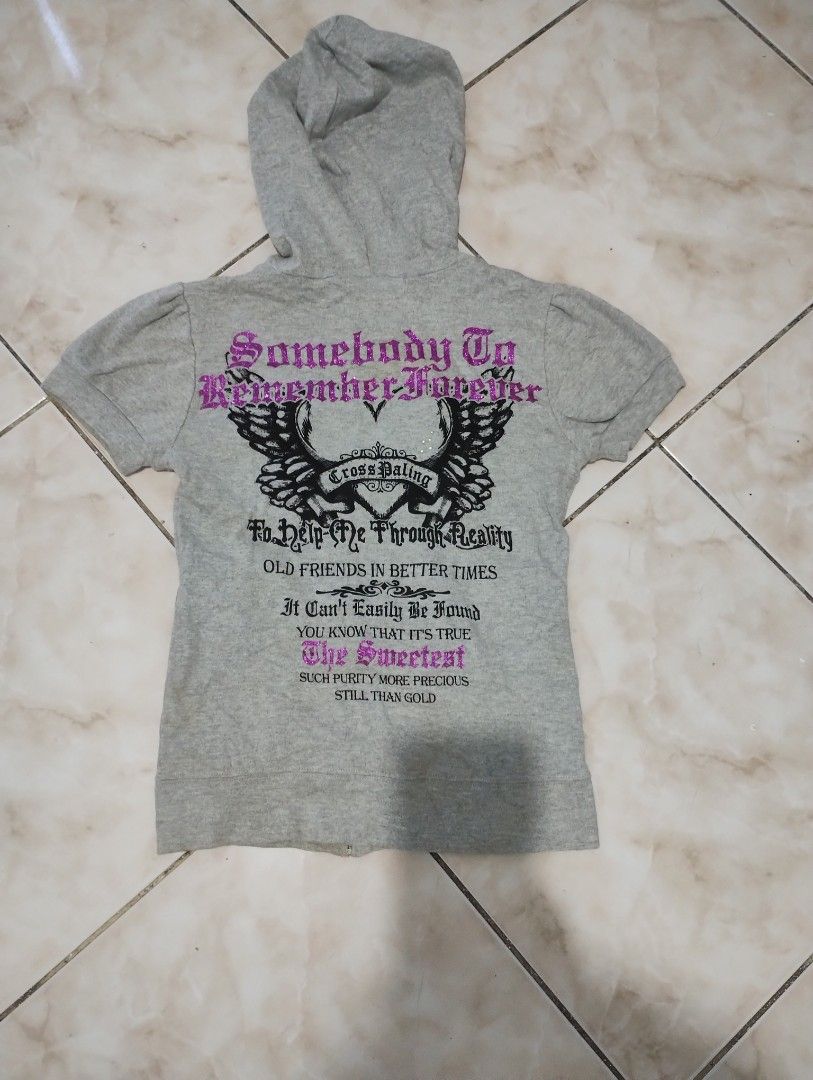 Blue Strive Grey Short Sleeve Zip Hoodie with Graphics (Category: Activewear) located in Imus. Submitted by darylg88358770 (Listing ID 1470645769, Image 3). Description: - Brand/Style: Blue Strive grey short sleeve zip-up hoodie - Aesthetic: True Y2K streetwear vibe - Design: Small glittery purple/black front graphic; large winged cross back graphic with "Somebody To Remember Forever" and "Old Friends In Better Times" text - Details: Attached hoo