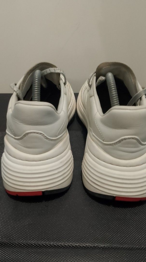 Bottega Veneta White Leather Sneakers (Category: Sneakers & Footwear) located in Pasig City. Submitted by lonski1181 (Listing ID 1470687396, Image 3). Description: - Brand: Bottega Veneta - Color: White with red sole accents - Material: Premium leather upper and lining - Features: Chunky platform sole, branded logo laces, embossed tongue logo, branded insoles - Origin: Made in Italy - Condition: Normal signs of wear visible on the leather uppers 