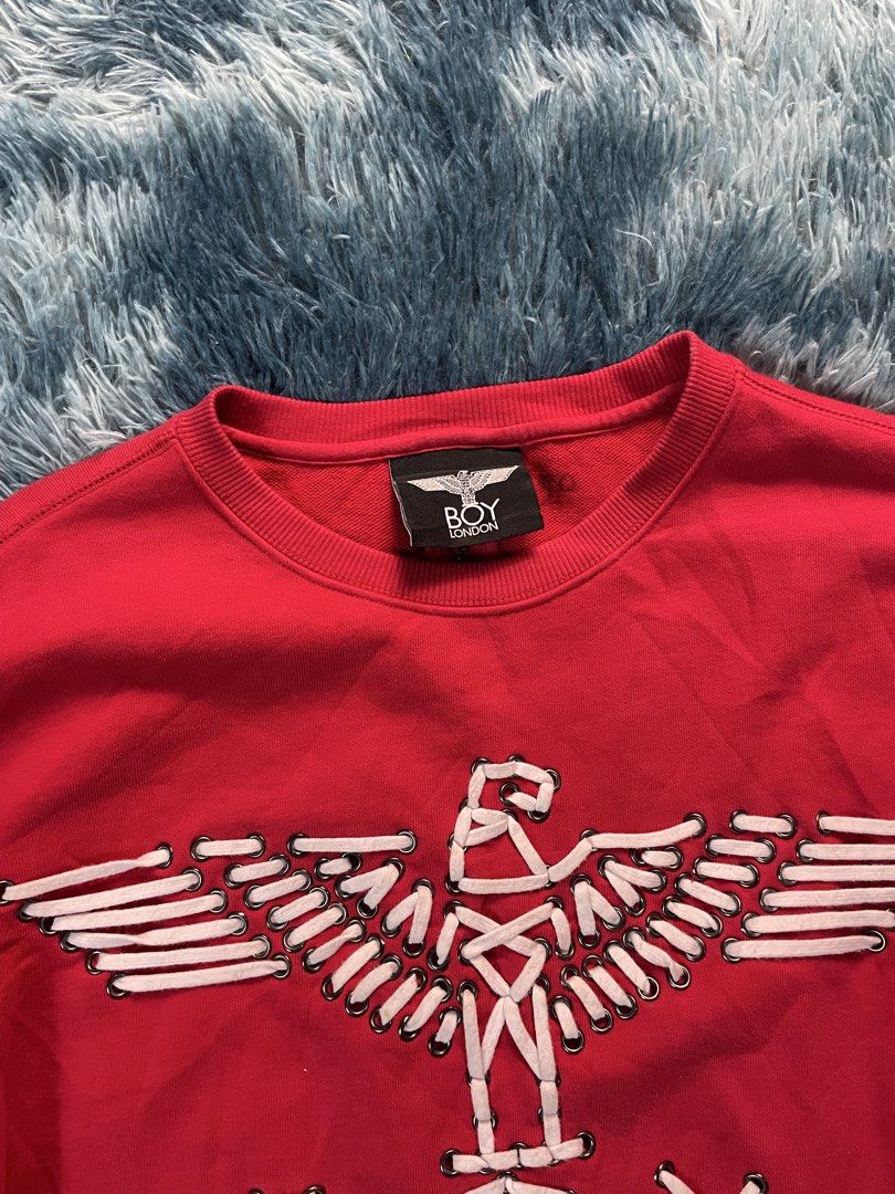 Boy London Red Laced Eagle Sweatshirt (Category: Coats, Jackets and Outerwear) located in Manila. Submitted by jssur (Listing ID 1470684800, Image 2). Description: - Brand: Red Boy London - Design: Iconic eagle graphic made from white laces and eyelets - Details: "WE ARE THE YOUTH OF TOMORROW" text on the right sleeve - Features: Front kangaroo pocket and a full zipper running down the center of the back - Fit: Pit-to-pit measures roughly 21 inch