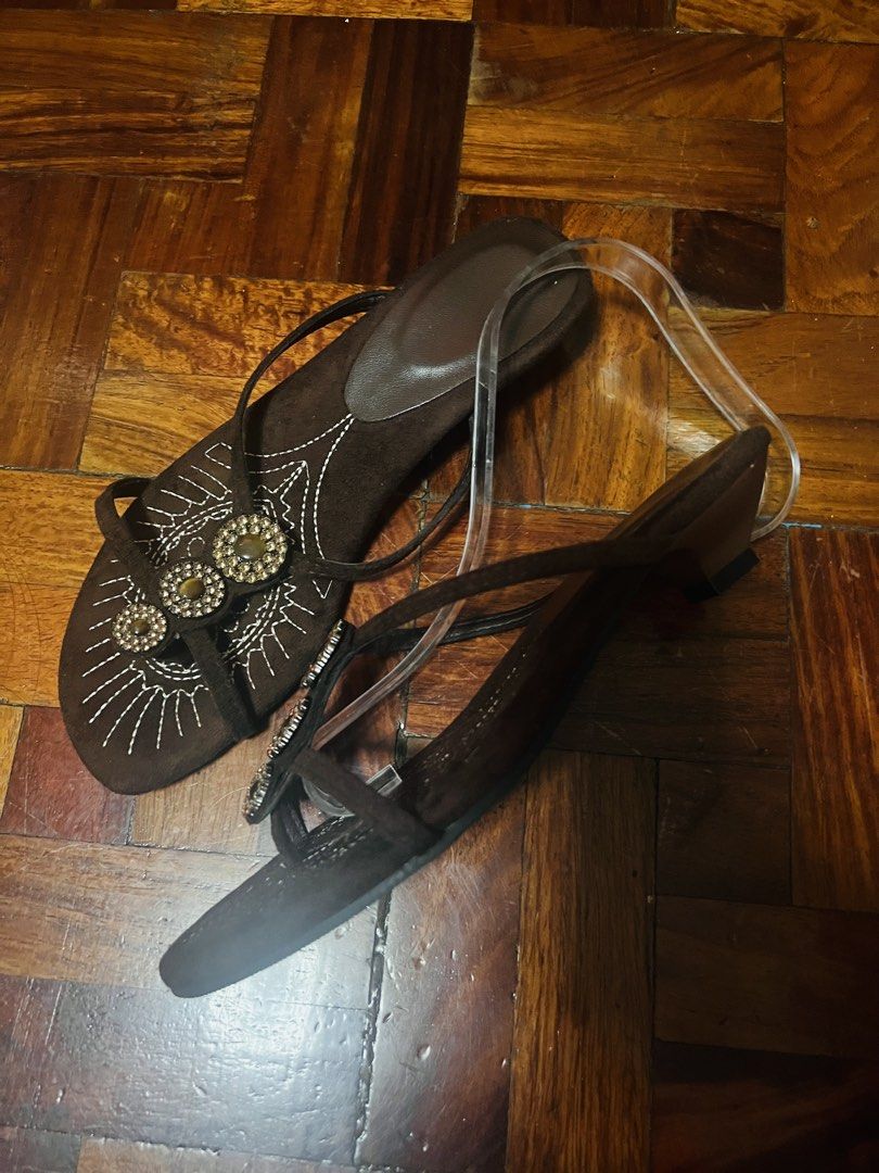 Brown Beaded Embroidered Low Heel Sandals (Category: Flats & Sandals) located in Manila. Submitted by maimaimai.store (Listing ID 1470674771, Image 2). Description: - Brown suede-like material - Decorative white embroidery across the toes - Three circular rhinestone embellishments on the top strap - Comfortable low heel design for easy walking - Convenient slip-on style with thin supportive straps - sandals only, no box.