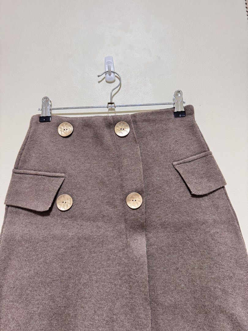 Brown Knit Skirt (Category: Skirts) located in Manila. Submitted by seayouncey (Listing ID 1470715291, Image 3). Description: Size 26 - 30 inches Length 17 inches - Brand: Azara Paris - Color: Brown - Size: TU (Fits most) - Design: Double-breasted look with 4 large textured gold buttons and 2 decorative side pocket flaps - Comfort: Black inner elastic waistband for a flexible, stretch fit - Material: Thick, warm woven textured fabric - Condition: