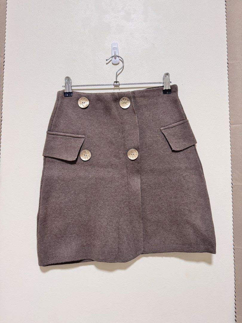 Brown Knit Skirt (Category: Skirts) located in Manila. Submitted by seayouncey (Listing ID 1470715291, Image 1). Description: Size 26 - 30 inches Length 17 inches - Brand: Azara Paris - Color: Brown - Size: TU (Fits most) - Design: Double-breasted look with 4 large textured gold buttons and 2 decorative side pocket flaps - Comfort: Black inner elastic waistband for a flexible, stretch fit - Material: Thick, warm woven textured fabric - Condition: