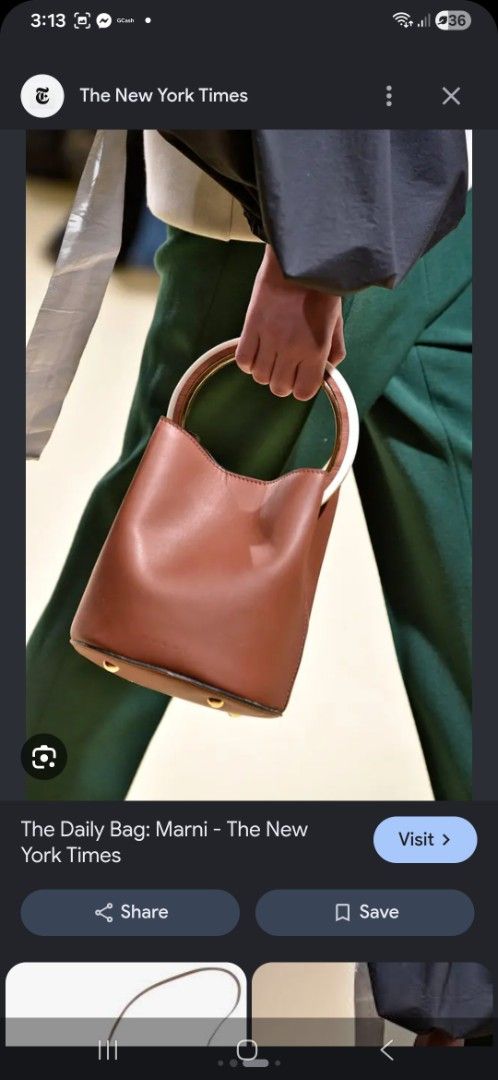 Brown Leather Bucket Bag with Circular Handle (Category: Luxury Bags & Wallets) located in Taguig. Submitted by jegadablo (Listing ID 1470741315, Image 1). Description: - Color & Material: Tan brown leather bucket bag - Handle: Circular top handle with stylish white and gold contrast - Base: Structured base equipped with four metal protective feet - Closure: Secure magnetic snap button at the top - Interior: Unlined with a spacious single compart
