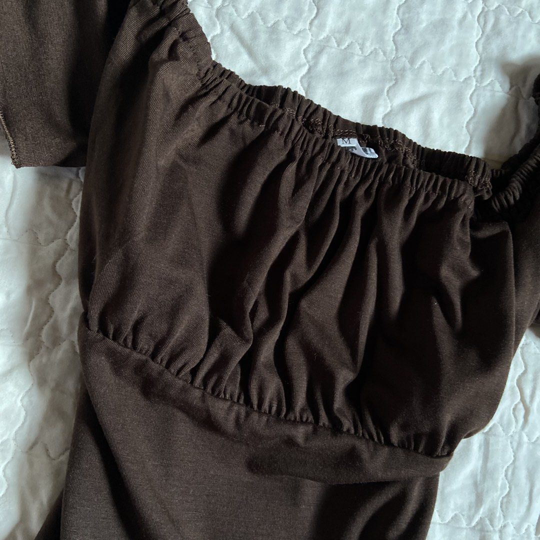 Brown Off-Shoulder Ruffle Top (Category: Blouses) located in Libungan. Submitted by whimsyypetal (Listing ID 1470703959, Image 3). Description: - Color: Brown - Size: Medium - Style: Off-shoulder top with short cap sleeves - Details: Elastic neckline and cute gathered ruched front - Fabric: Soft and stretchy - Condition: Worn once for a quick mirror selfie, freshly washed and stored properly.