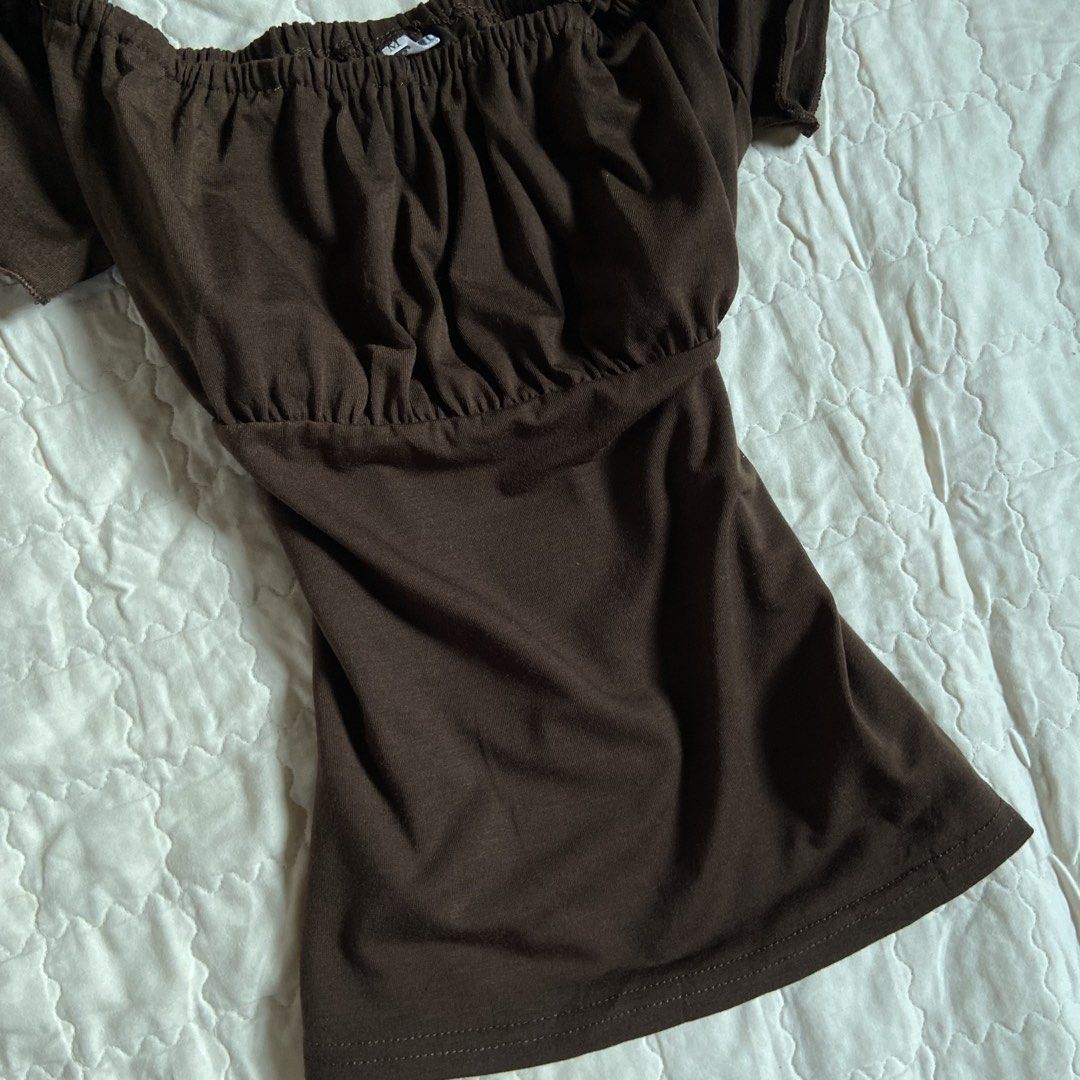 Brown Off-Shoulder Ruffle Top (Category: Blouses) located in Libungan. Submitted by whimsyypetal (Listing ID 1470703959, Image 2). Description: - Color: Brown - Size: Medium - Style: Off-shoulder top with short cap sleeves - Details: Elastic neckline and cute gathered ruched front - Fabric: Soft and stretchy - Condition: Worn once for a quick mirror selfie, freshly washed and stored properly.