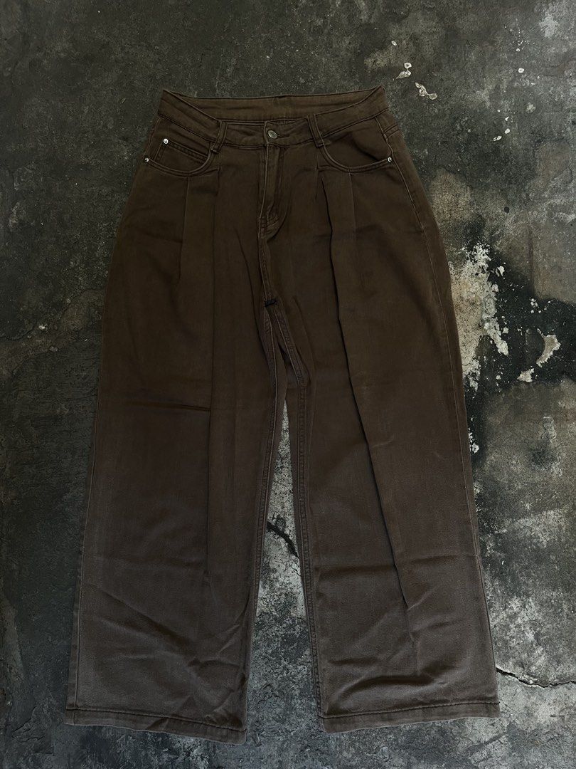 Brown Wide Leg Pleated Denim Pants (Category: Jeans) located in Iloilo. Submitted by astaaa777 (Listing ID 1470622491, Image 1). Description: 28-30 waist 40 length 10.5 lo - Color: Deep brown earthy tone - Style: Wide-leg denim pants with front pleats - Fit: Relaxed fit through the legs - Details: Button closure, four-pocket styling with metal rivets - Condition: Clean, no major flaws - Pairing: Easy to match with casual tees and hoodies.