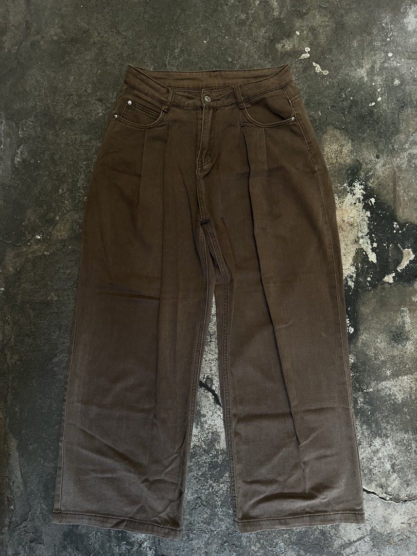 Brown Wide Leg Pleated Denim Pants (Category: Jeans) located in Iloilo. Submitted by astaaa777 (Listing ID 1470622491, Image 2). Description: 28-30 waist 40 length 10.5 lo - Color: Deep brown earthy tone - Style: Wide-leg denim pants with front pleats - Fit: Relaxed fit through the legs - Details: Button closure, four-pocket styling with metal rivets - Condition: Clean, no major flaws - Pairing: Easy to match with casual tees and hoodies.