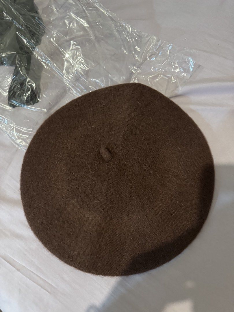 Brown woolen beret winter hat (Category: Hats & Beanies) located in Manila. Submitted by naomis_room (Listing ID 1470680523, Image 1). Description: - Color: Solid brown - Material: Soft wool texture - Design: Classic round shape with traditional top stem - Condition: Excellent, comes with original inner paper insert to maintain shape - Style: Great cooler weather accessory, easy to pair with coats and sweaters.