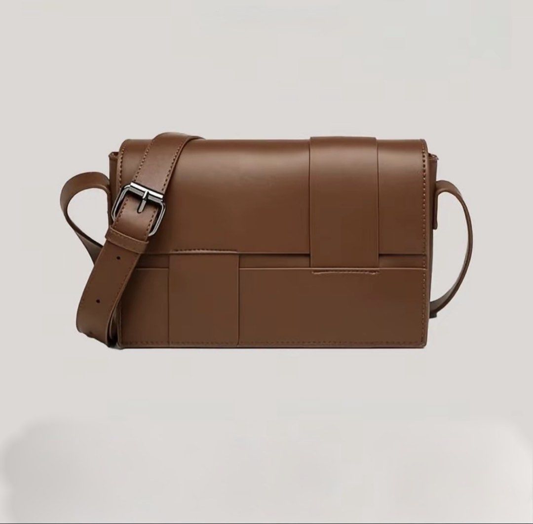 Brown Woven Flap Crossbody Bag (Category: Cross-body Bags) located in Dasmarinas. Submitted by rammonton (Listing ID 1470581948, Image 1). Description: - Color: Brown - Material: Faux leather with distinctive woven front flap - Hardware: Silver-toned with adjustable shoulder strap - Interior: Clean, lined with black patterned fabric, features a zippered middle divider and slip pockets - Condition: Well-maintained structure - Perfect size for dail
