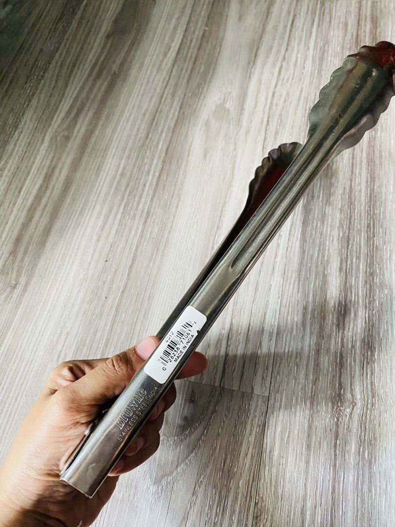 Browne Stainless Steel Kitchen Tong (Category: Cookware & Accessories) located in Caloocan City. Submitted by lovemyclothes21 (Listing ID 1470574526, Image 1). Description: - Authentic Browne stainless steel kitchen tongs, made in India - Scalloped edges provide a secure and firm grip on food - Durable metal construction built for everyday heavy-duty use - Standard length offers safe reach and control over hot pans - Essential kitchen tool for bo