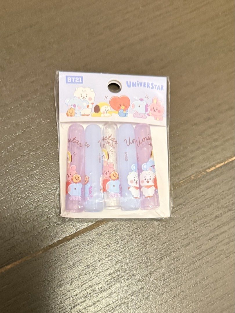BT21 Universtar Pencil Cap Set (Category: K-Wave Merchandise) located in Marikina City. Submitted by culose (Listing ID 1470680796, Image 1). Description: - Official Line Friends merchandise featuring BT21 characters - Pack of 5 soft, translucent pencil caps in purple, blue, and clear with glitter - Brand new and unopened in pristine packaging - Perfect for school, office, or as a gift for K-pop fans.