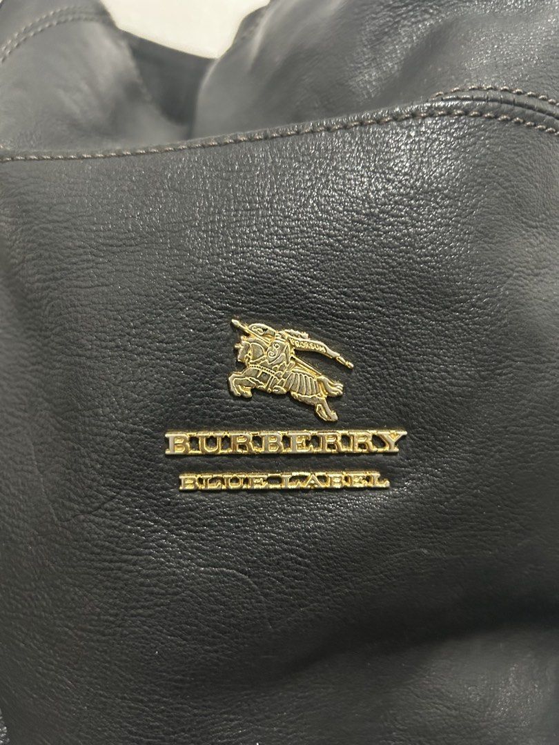 Burberry Blue Label Black Leather Shoulder Bag (Category: Luxury Bags & Wallets) located in Angeles City. Submitted by cassey_phoenix (Listing ID 1470682090, Image 2). Description: - Authentic Burberry Blue Label shoulder bag in classic black leather - Eye-catching gold-tone hardware featuring the prominent equestrian knight logo emblem - Convenient zip pockets on both sides with stylish leather pull tabs - Secure single shoulder strap attached w
