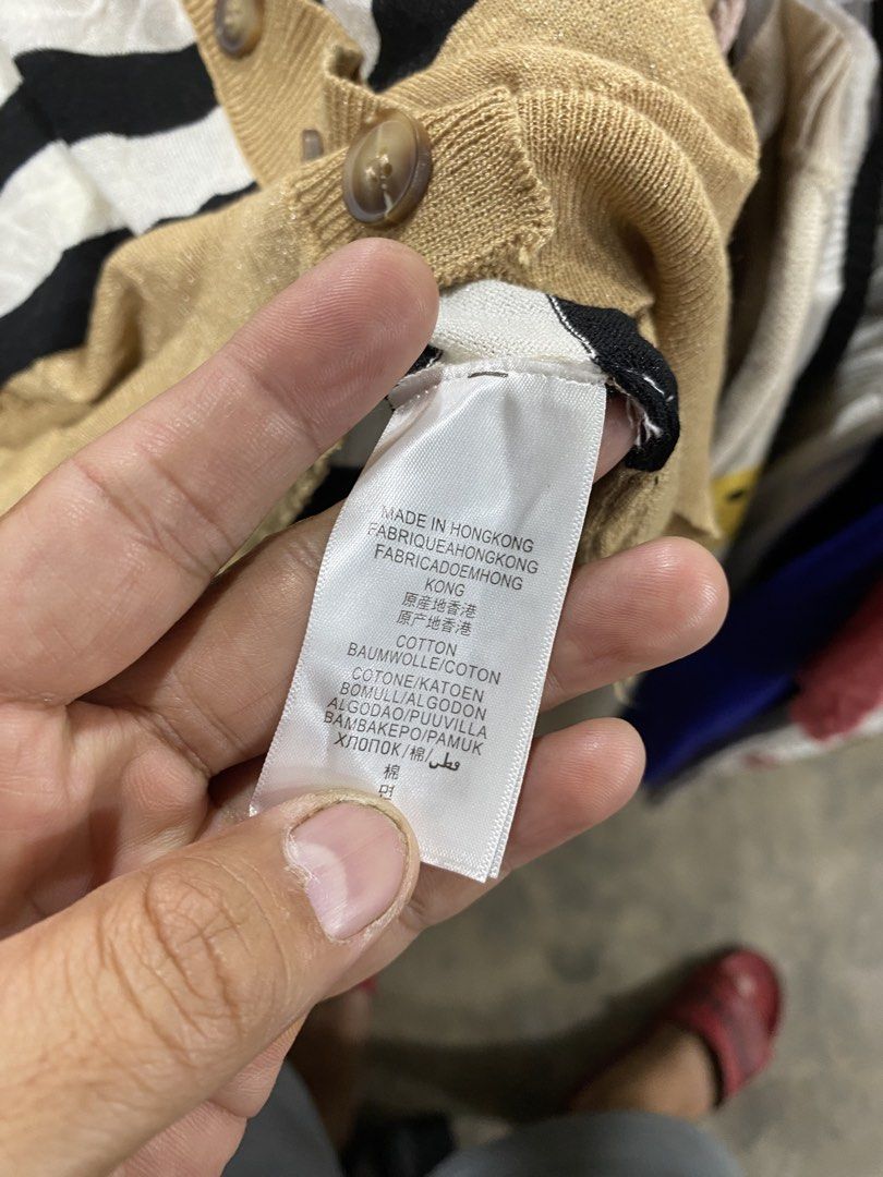Burberry Brit Striped Button Up Cardigan (Category: Longsleeves) located in Alburquerque. Submitted by zanegavynn43872 (Listing ID 1470597230, Image 3). Description: - Brand: Burberry Brit - Material: 100% Cotton (Made in Hong Kong) - Design: Classic black, white, and tan horizontal stripes with a bold orange chest accent - Features: V-neck, front button closure, and two front pockets - Care: Machine wash cold - Condition: Excellent, well-maintai