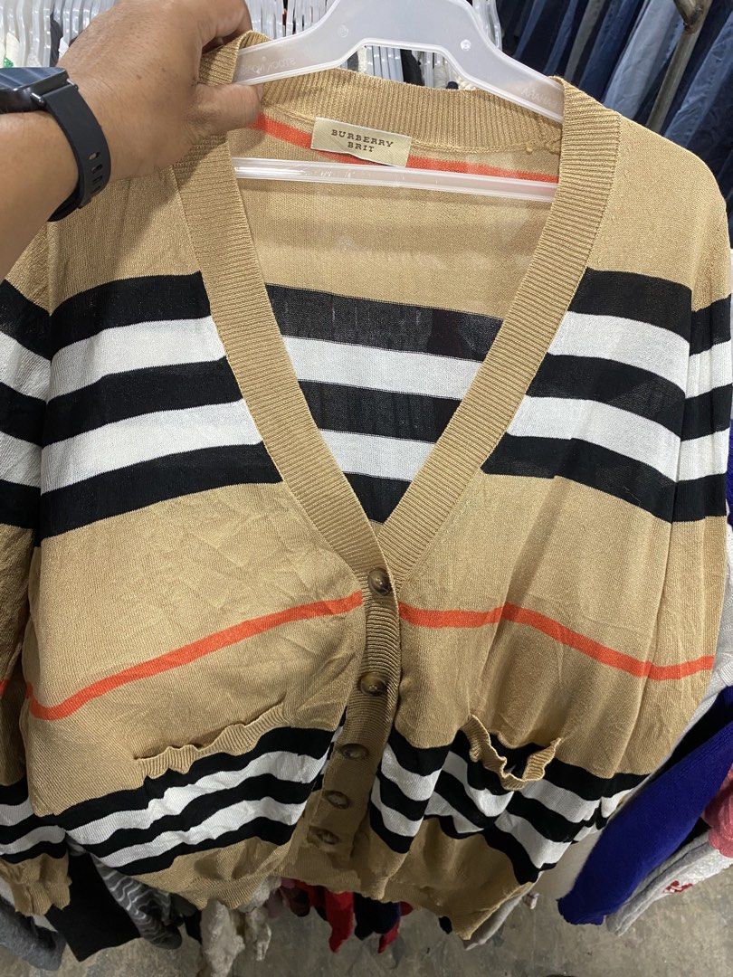 Burberry Brit Striped Button Up Cardigan (Category: Longsleeves) located in Alburquerque. Submitted by zanegavynn43872 (Listing ID 1470597230, Image 1). Description: - Brand: Burberry Brit - Material: 100% Cotton (Made in Hong Kong) - Design: Classic black, white, and tan horizontal stripes with a bold orange chest accent - Features: V-neck, front button closure, and two front pockets - Care: Machine wash cold - Condition: Excellent, well-maintai