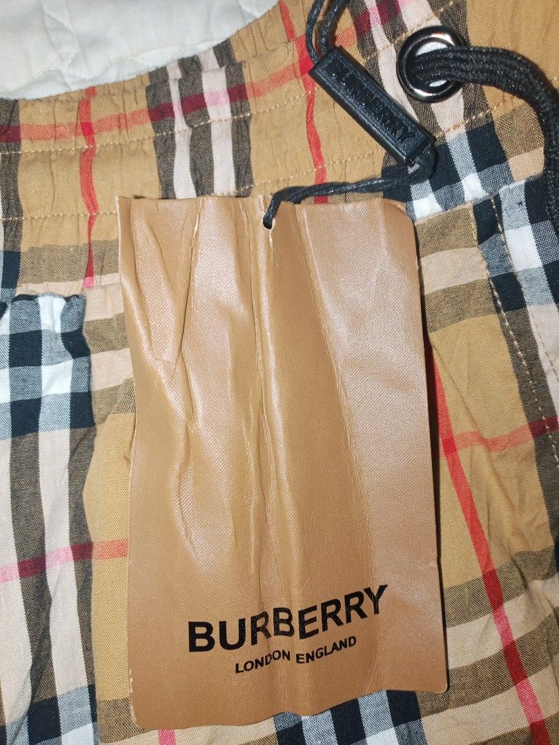 Burberry Check Drawstring Trousers (Category: Trousers) located in Allen. Submitted by milyonaryung_gipit (Listing ID 1470567133, Image 2). Description: - Brand: Burberry - Style: Check print trousers with distinctive side stripes - Size: Medium - Material: 100% cotton - Features: Elastic waistband with adjustable black drawstring - Condition: Brand new with original tag attached.