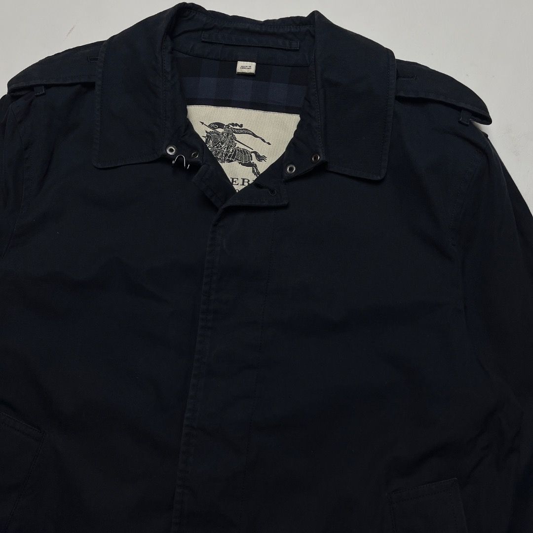 Burberry London Navy Harrington Jacket Size (Category: Coats, Jackets and Outerwear) located in Caloocan City. Submitted by achilles_grails (Listing ID 1470564587, Image 2). Description: - Brand: Burberry London - Color: Dark Navy Blue - Size: 48 R - Material: 100% cotton outer/body lining, 100% viscose sleeve lining - Origin: Made in the UK - Design: Classic check lining, shoulder epaulets, buckled cuffs, and neck button closure - Condition: Pre