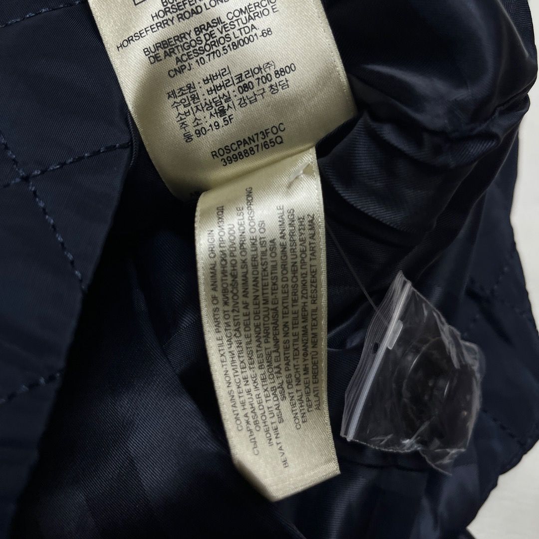 Burberry Quilted Nylon Trench Coat (Category: Coats, Jackets and Outerwear) located in Caloocan City. Submitted by achilles_grails (Listing ID 1470592994, Image 3). Description: - Brand: Burberry - Style: Quilted Nylon Trench Coat / Double-Breasted Jacket - Color: Dark Navy Blue - Size: XL (185/104B) - Material: 100% Polyester outer shell, 100% Viscose lining - Features: Diamond-quilted pattern, matching waist belt, shoulder epaulettes, branded b