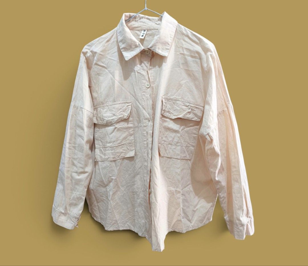 Button-Down Long Sleeve Shirt with Pockets (Category: Longsleeves) located in Taguig. Submitted by deyerreC2020 (Listing ID 1470608631, Image 2). Description: sale tops L-semi XL preloved nice pastel peach/apricot color tops in good stocked condition button-down shirt with drop shoulders and double chest pockets. Relaxed, oversized fit. Measures on photos . Button cuffs on sleeves. Small ink stain near one cuff( can wash though, shown in close-up
