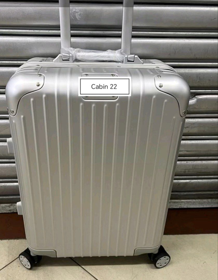 Cabin 22 Luggage Hard Shell Suitcase (Category: Luggage) located in Manila. Submitted by dh3nz1 (Listing ID 1470742041, Image 1). Description: - Size: Cabin 22 hard shell suitcase - Design: Modern vertical ribbed finish with a sleek metal tag plate - Mobility: 4 smooth-rolling spinner wheels and a telescoping handle - Comfort: Retractable top handle with protective plastic wrap - Colors: Available in silver, gold, and black - Durability: Sturdy b
