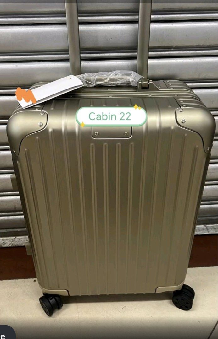 Cabin 22 Luggage Hard Shell Suitcase (Category: Luggage) located in Manila. Submitted by dh3nz1 (Listing ID 1470742041, Image 2). Description: - Size: Cabin 22 hard shell suitcase - Design: Modern vertical ribbed finish with a sleek metal tag plate - Mobility: 4 smooth-rolling spinner wheels and a telescoping handle - Comfort: Retractable top handle with protective plastic wrap - Colors: Available in silver, gold, and black - Durability: Sturdy b