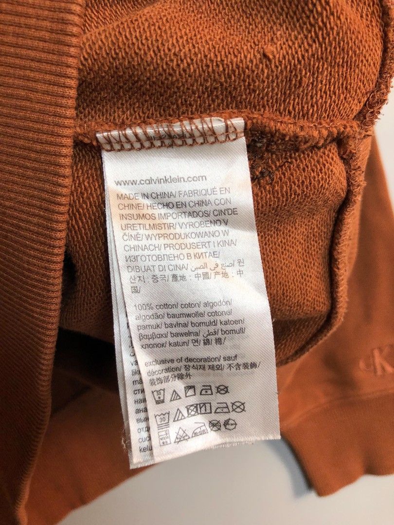 Calvin Klein Jeans Embossed Monogram Sweatshirt (Category: Coats, Jackets and Outerwear) located in Manila. Submitted by silentwolf_3303a7 (Listing ID 1470559455, Image 2). Description: * Color: Warm Brown / Copper * Size: Large (27.5" Length x 22.5" Width) * Condition: 7/10 (Good vintage condition) * Details: Raised metallic CK logo on chest + embroidered logo on wrist. May minimal print cracking for that vintage distressed aesthetic. .