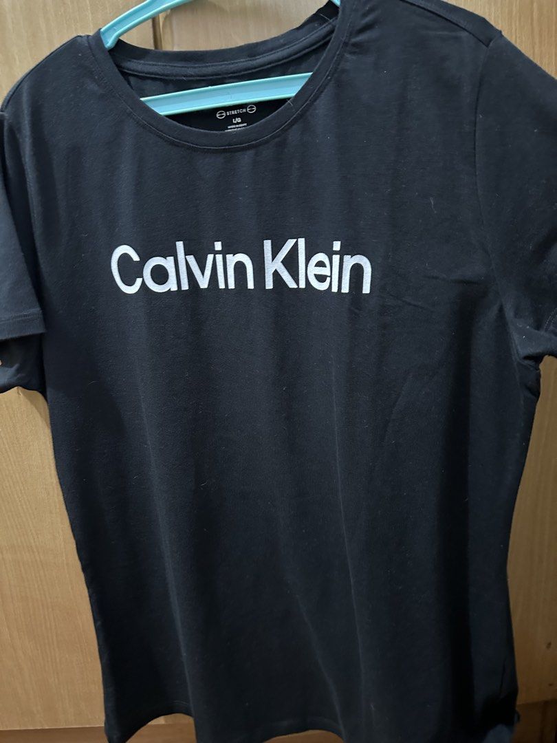Calvin Klein Performance Black Stretch T-Shirt Size L (Category: Shirts) located in Balanga. Submitted by jamilbeauty5 (Listing ID 1470743145, Image 1). Description: - Brand: Calvin Klein Performance - Color: Solid Black - Size: L - Material: 95% Cotton, 5% Spandex (Made in Egypt) - Fit: Comfortable and stretchable - Ideal for: Workouts or casual wear - Care: Machine wash cold with like colors - BRAND NEW- washed but NOT worn GUARANTEED ORIGINAL!