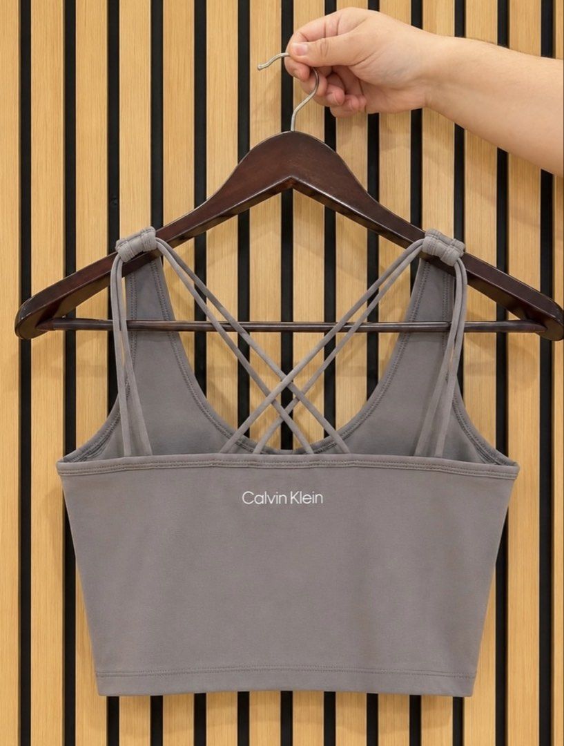 Calvin Klein Performance Strappy Back Crop Top Grey (Category: Activewear) located in Manila. Submitted by ayoltomagotchi (Listing ID 1470662066, Image 2). Description: - Brand: Calvin Klein Performance - Item: Athletic crop top - Color: Grey with subtle white logo on back band - Design: V-neck front with stylish strappy cross-back - Material: Soft stretch fabric for maximum comfort - Condition: Brand new with tags (BNWT) - Ideal for: Gym workout