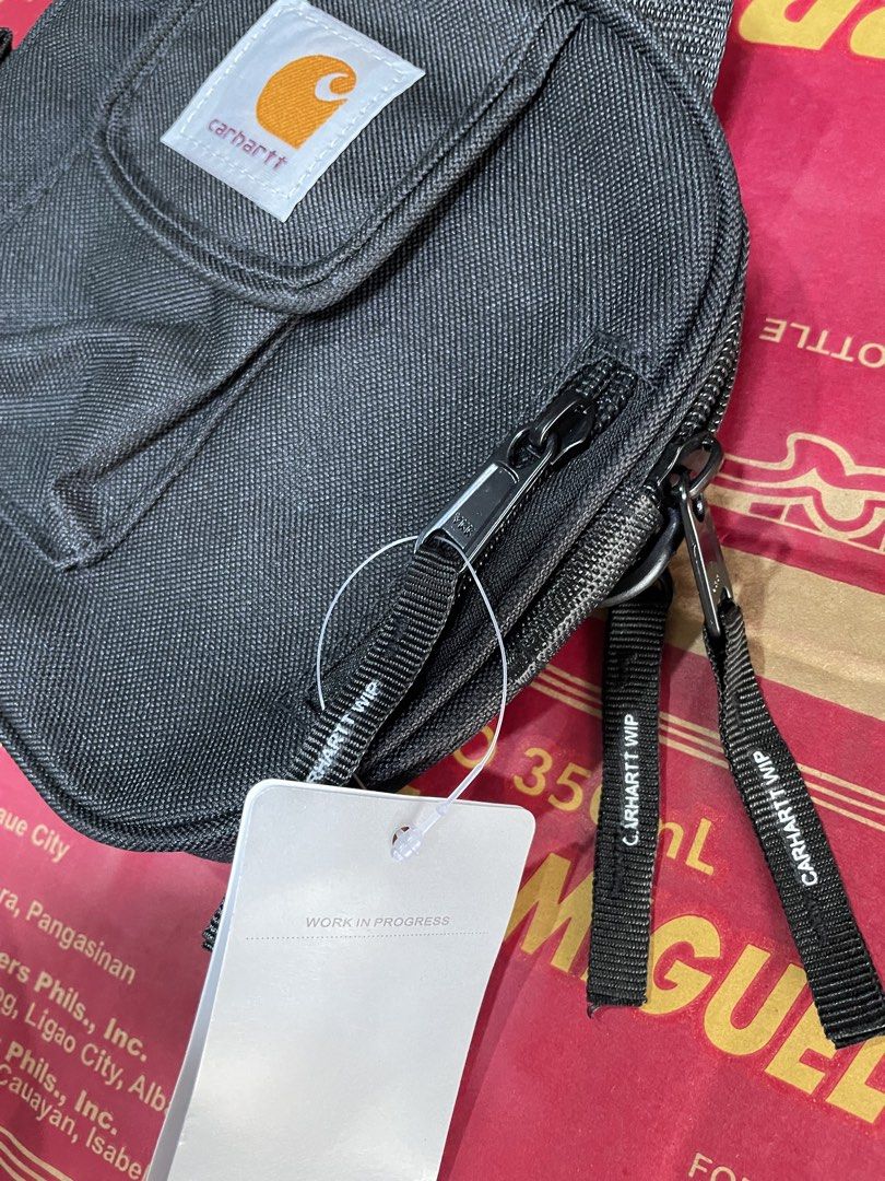 Carharrt WIP Black Parcel Crossbody Bag (Category: Sling Bags) located in Baguio. Submitted by elayor3 (Listing ID 1470701099, Image 2). Description: - Brand: Carhartt WIP - Color: Black - Condition: Brand new with tags - Material: Durable heavy-duty canvas - Hardware: YKK zippers with branded pull tabs - Compartments: Multiple zipped pockets and front flap pocket with iconic logo patch - Versatility: Adjustable strap for shoulder or crossbody we