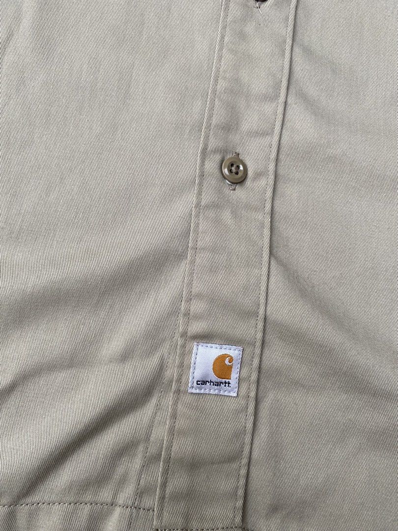 Carhartt Beige Short Sleeve (Category: Tshirts & Polo Shirts ) located in Manila. Submitted by yukimaca666 (Listing ID 1470608666, Image 3). Description: - Brand: Carhartt - Style: Short sleeve work shirt / button-down - Color: Khaki beige - Size: L (Tag) - Material: 65% polyester, 35% cotton blend - Origin: Made in Mexico - Features: Two chest pockets, woven Carhartt logo patch near bottom hem, inner collar tag - Condition: Excellent pre-owned c