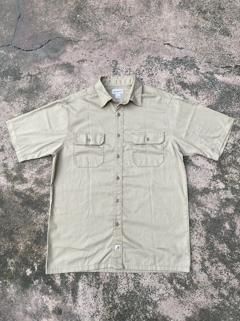 Carhartt Beige Short Sleeve (Category: Tshirts & Polo Shirts ) located in Manila. Submitted by yukimaca666 (Listing ID 1470608666, Image 2). Description: - Brand: Carhartt - Style: Short sleeve work shirt / button-down - Color: Khaki beige - Size: L (Tag) - Material: 65% polyester, 35% cotton blend - Origin: Made in Mexico - Features: Two chest pockets, woven Carhartt logo patch near bottom hem, inner collar tag - Condition: Excellent pre-owned c