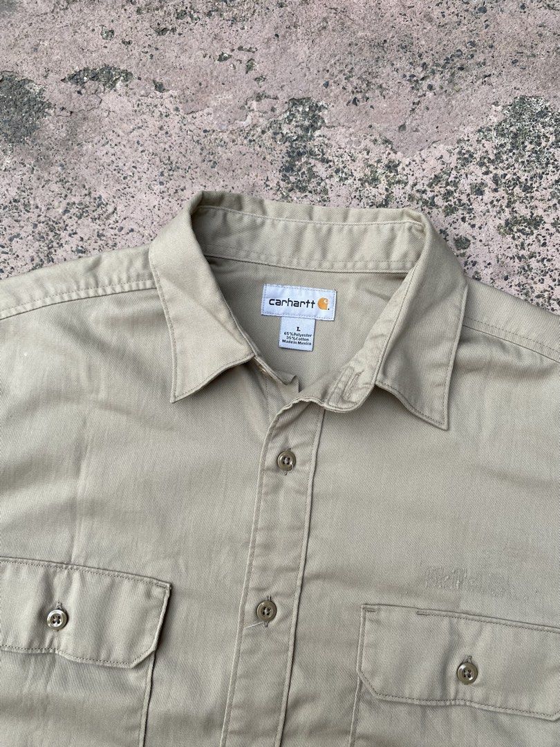 Carhartt Beige Short Sleeve (Category: Tshirts & Polo Shirts ) located in Manila. Submitted by yukimaca666 (Listing ID 1470608666, Image 1). Description: - Brand: Carhartt - Style: Short sleeve work shirt / button-down - Color: Khaki beige - Size: L (Tag) - Material: 65% polyester, 35% cotton blend - Origin: Made in Mexico - Features: Two chest pockets, woven Carhartt logo patch near bottom hem, inner collar tag - Condition: Excellent pre-owned c