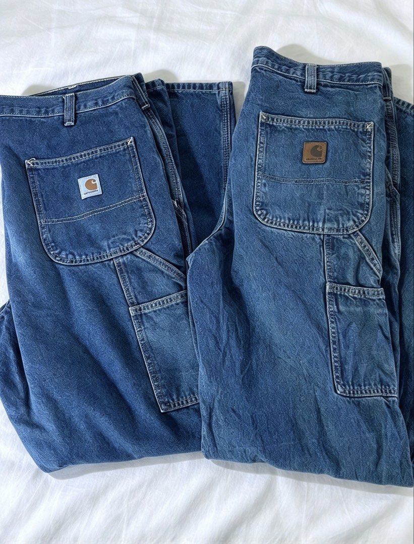 Carhartt Blue Denim Work Jeans Carpenter Pants (Category: Jeans) located in Nampicuan. Submitted by aireann_10 (Listing ID 1470603633, Image 1). Description: - Bundle includes 2 pairs of classic blue wash Carhartt denim work pants - Heavy-duty fabric construction built for job sites and everyday wear - Practical utility side pockets on both legs - Iconic Carhartt logo patch on the back pocket - Comfortable straight leg fit.