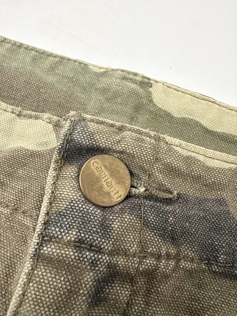 Carhartt Camo Cargo Skirt (Category: Skirts) located in Alfonso. Submitted by jbcamet (Listing ID 1470688864, Image 2). Description: - Authentic Carhartt woodland camo utility skirt - Heavy-duty cotton canvas material for a rugged workwear look - Functional cargo pockets on both sides - Metal branded front waist button closure - Iconic square Carhartt logo patch on the side pocket - Great streetwear staple - Note: Inside care tags are faded.