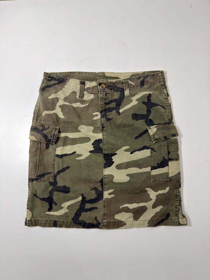 Carhartt Camo Cargo Skirt (Category: Skirts) located in Alfonso. Submitted by jbcamet (Listing ID 1470688864, Image 1). Description: - Authentic Carhartt woodland camo utility skirt - Heavy-duty cotton canvas material for a rugged workwear look - Functional cargo pockets on both sides - Metal branded front waist button closure - Iconic square Carhartt logo patch on the side pocket - Great streetwear staple - Note: Inside care tags are faded.