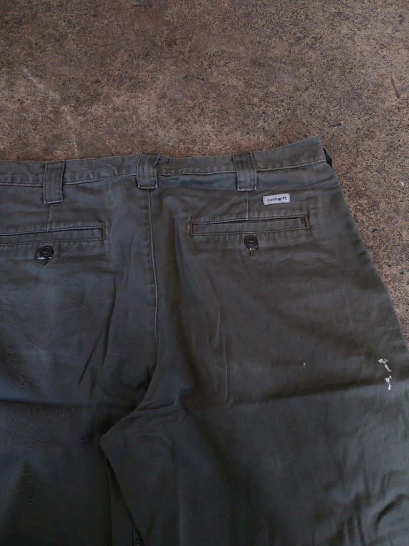 Carhartt Moss Green Work Shorts Size 34 (Category: Shorts) located in Legazpi City. Submitted by justinbarcelon (Listing ID 1470683745, Image 3). Description: - Brand: Carhartt - Item: Utility Shorts - Color: Moss Green - Size: Tagged 34 - Material: 100% cotton canvas - Closure: Button waist with zip fly - Features: Belt loops, back welt pockets with button closures and logo patch - Condition: Authentic workwear character with paint splatters and