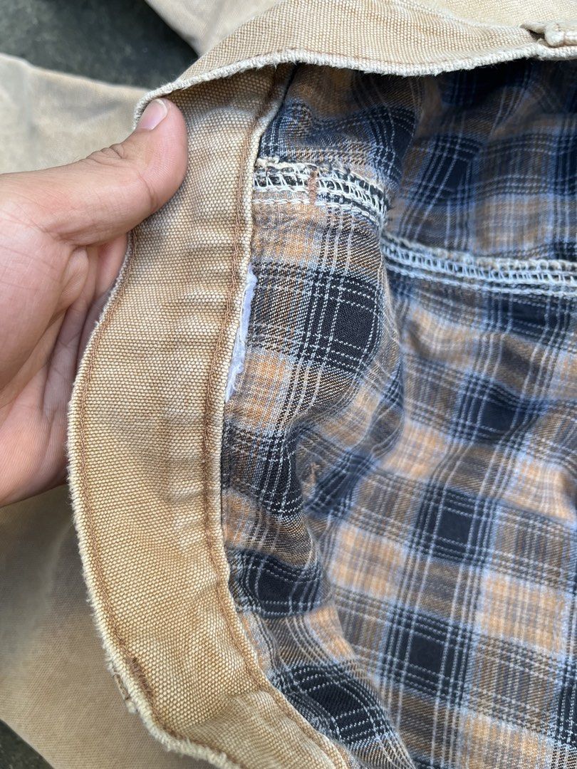 Carousell Carhartt Flannel Lined Duck Work Pants (Category: Jeans) located in Siniloan. Submitted by marceiron316276 (Listing ID 1470665334, Image 3). Description: - Brand: Vintage Carhartt - Color: Tan with blue and brown plaid flannel lining - Material: Thick, heavy-duty duck canvas cotton - Features: Double-knee reinforcement, utility pockets, and hammer loops - Condition: Classic workwear style with natural fading and wear throughout - Perfec